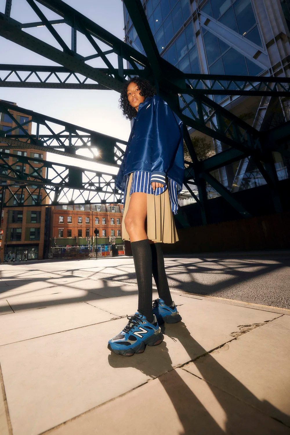 Streetwear Statement: Satin Jacket and Pleated Skirt with Blue and Black 9060s — New Balance 9060 Outfits 2027
