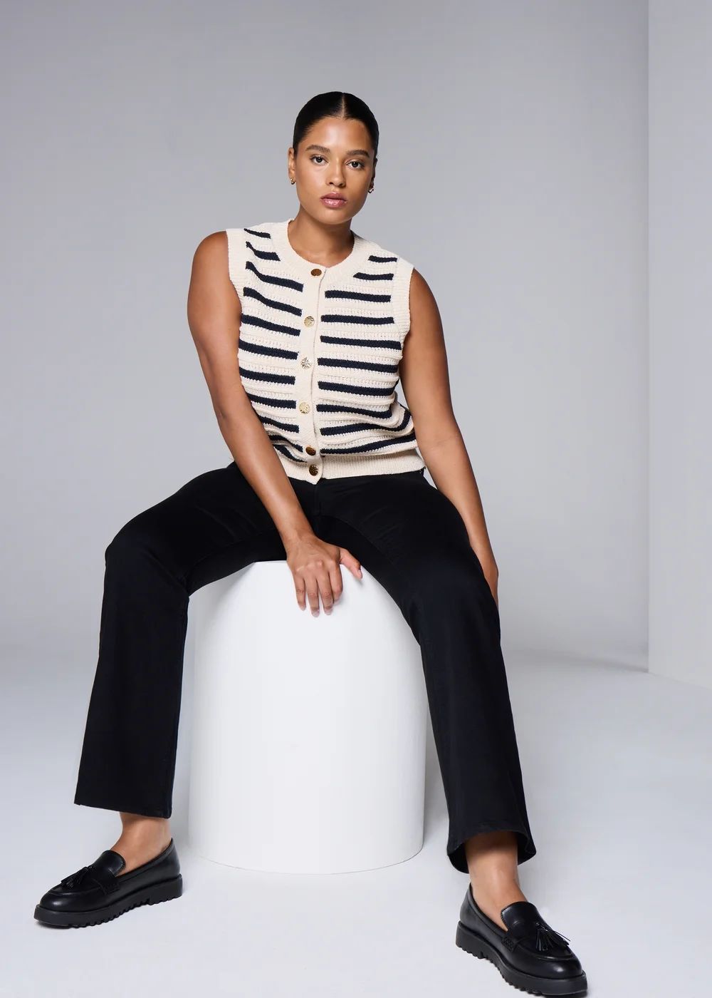 Black Bootcut Jeans with Striped Knit Vest and Loafers — Black Bootcut Jeans Outfits 2027
