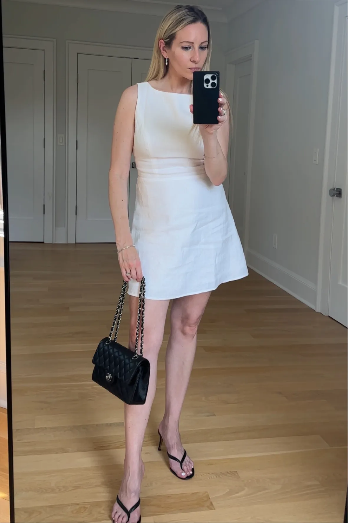White Linen Sleeveless Mini Dress with Quilted Handbag White Linen Sleeveless Mini Dress with Quilted Handbag — Summer Baby Shower Outfits 2027