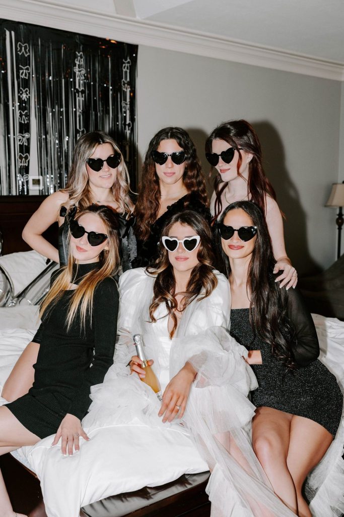 Bridal Party Contrast: White Gown Amidst Black Dresses Bridal Party Contrast: White Gown Amidst Black Dresses — Bride Bachelorette Outfits 2027