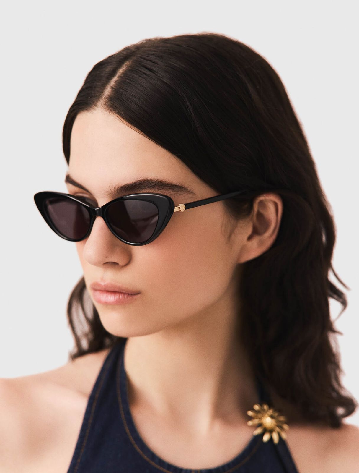 Denim Halter Top and Gold Brooch with Black Cat Eyes — Cat Eye Sunglasses Outfits 2027
