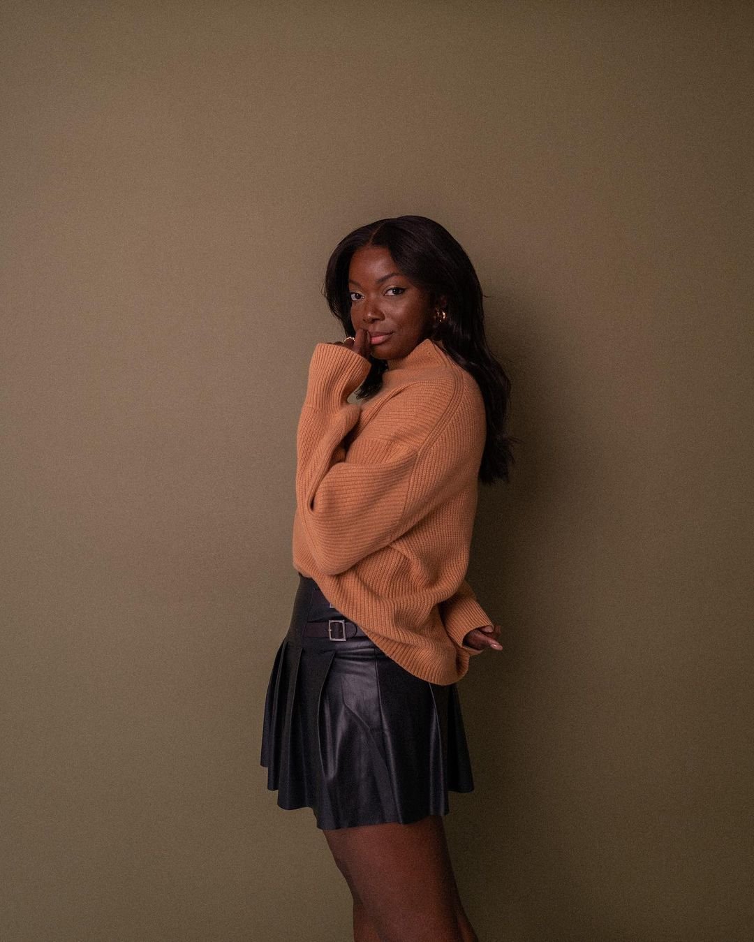 Black Leather Pleated Mini Skirt with Camel Oversized Sweater — Pleated Skirt Outfits 2027