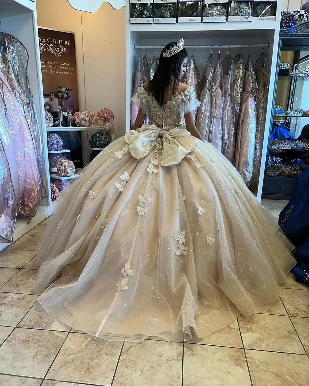 Quinceanera Champagne Ball Gown with Oversized Bow and Butterfly Appliques — Champagne Quinceanera Dress 2027