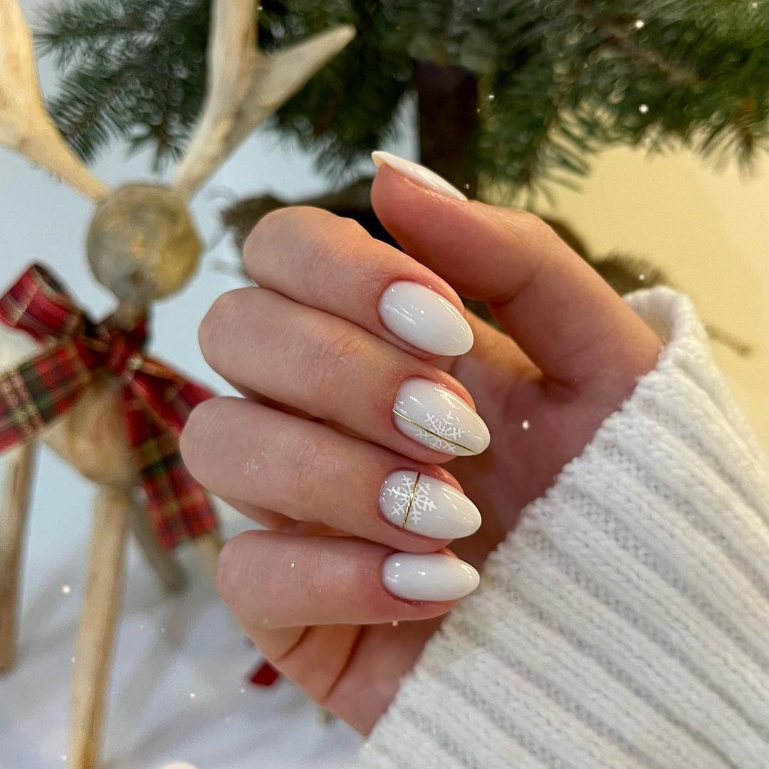 Opaque White Snowflake Gold Line Oval Nails Opaque White Snowflake Gold Line Oval Nails — Neutral Christmas Nails 2026