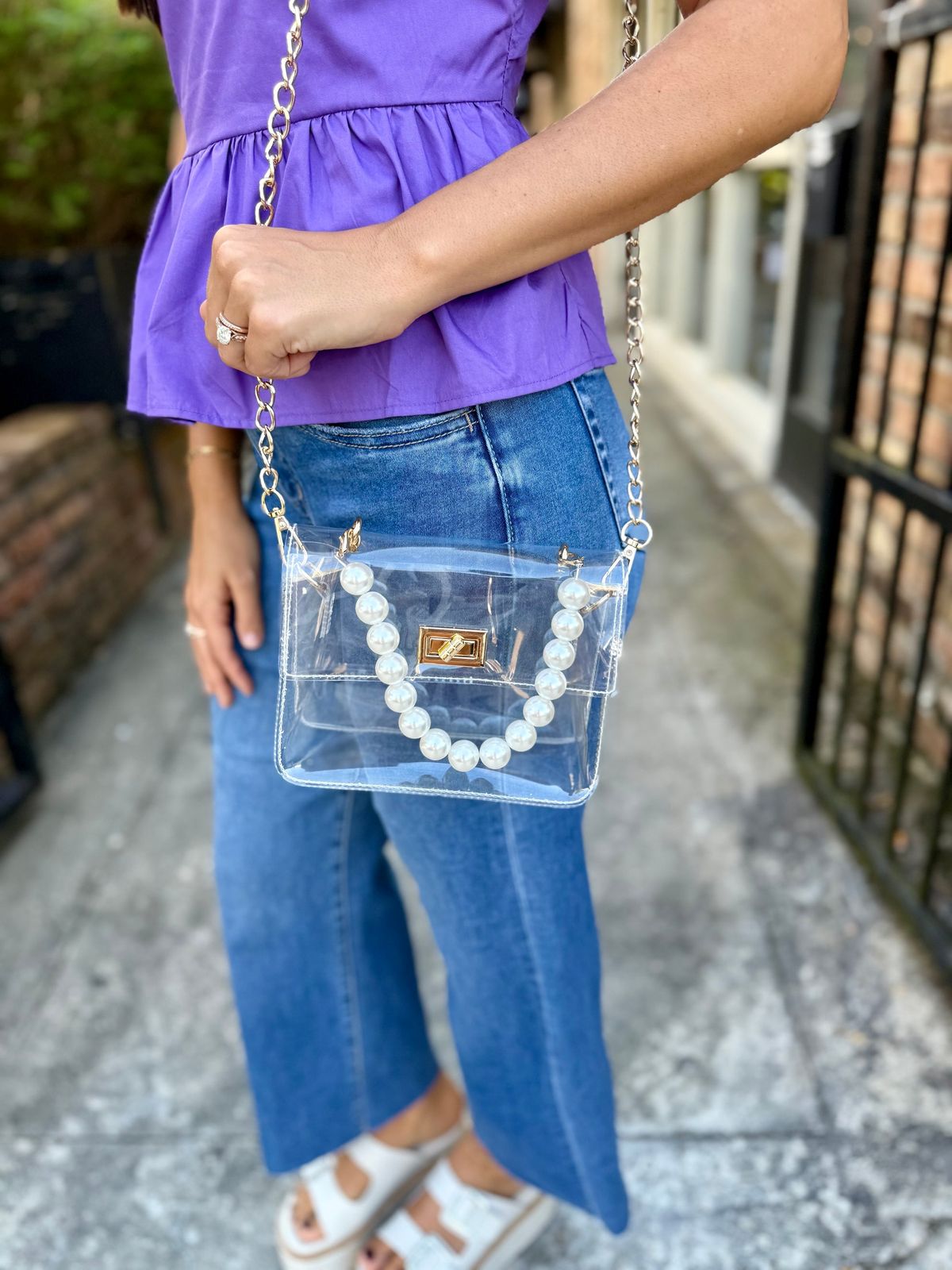 Peplum Top and Denim Jeans with a Pearl-Embellished Clear Bag — Clear Bag Outfits 2027
