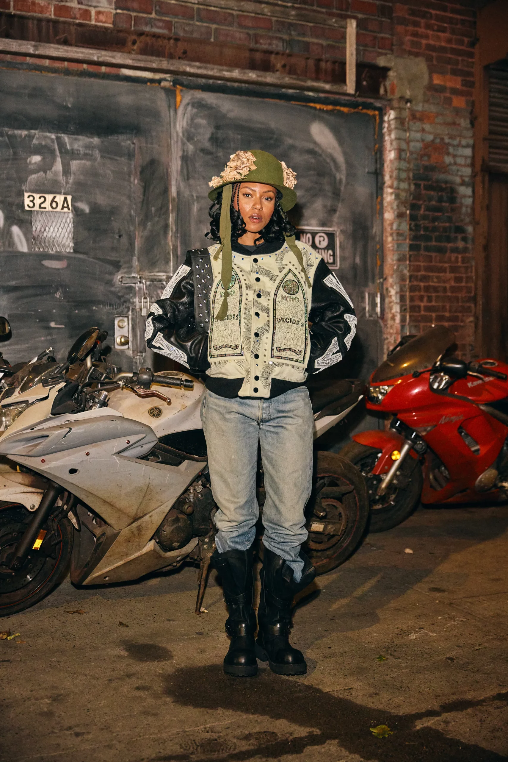 Layered Denim Jacket with Patterned Jacket and Green Hat — Denim Jacket Outfits 2027