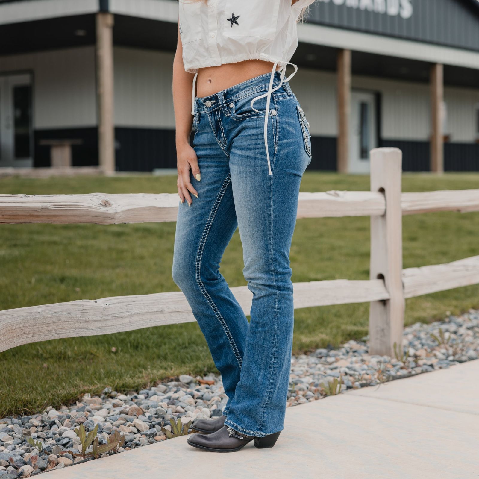 White Cropped Top with Star Detail and Blue Bootcut Jeans White Cropped Top with Star Detail and Blue Bootcut Jeans — Blue Bootcut Jeans Outfits 2027