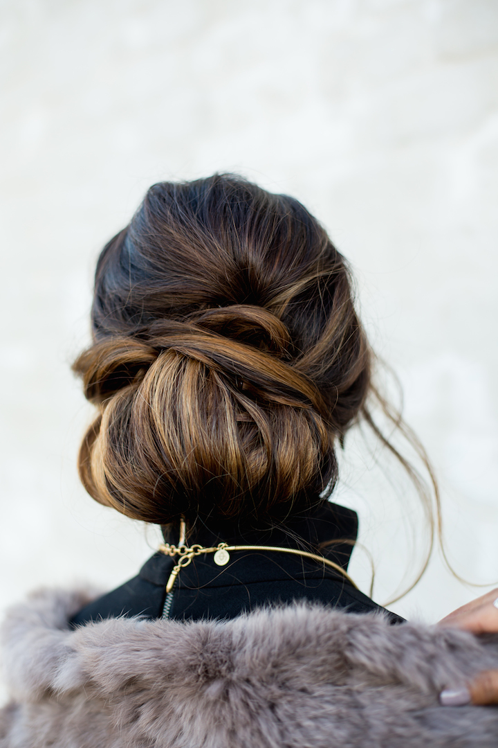 Low Braided Bun With Caramel Highlights — Holiday Party Hairstyles 2026