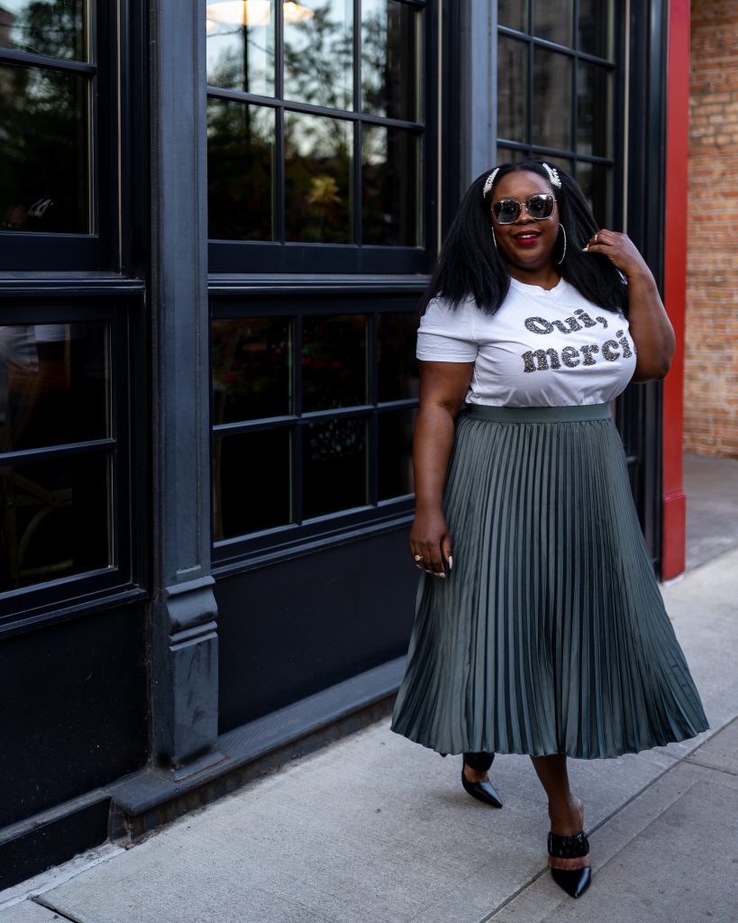 Olive Green Satin Pleated Skirt with Graphic T-Shirt and Heels — Pleated Skirt Outfits 2027