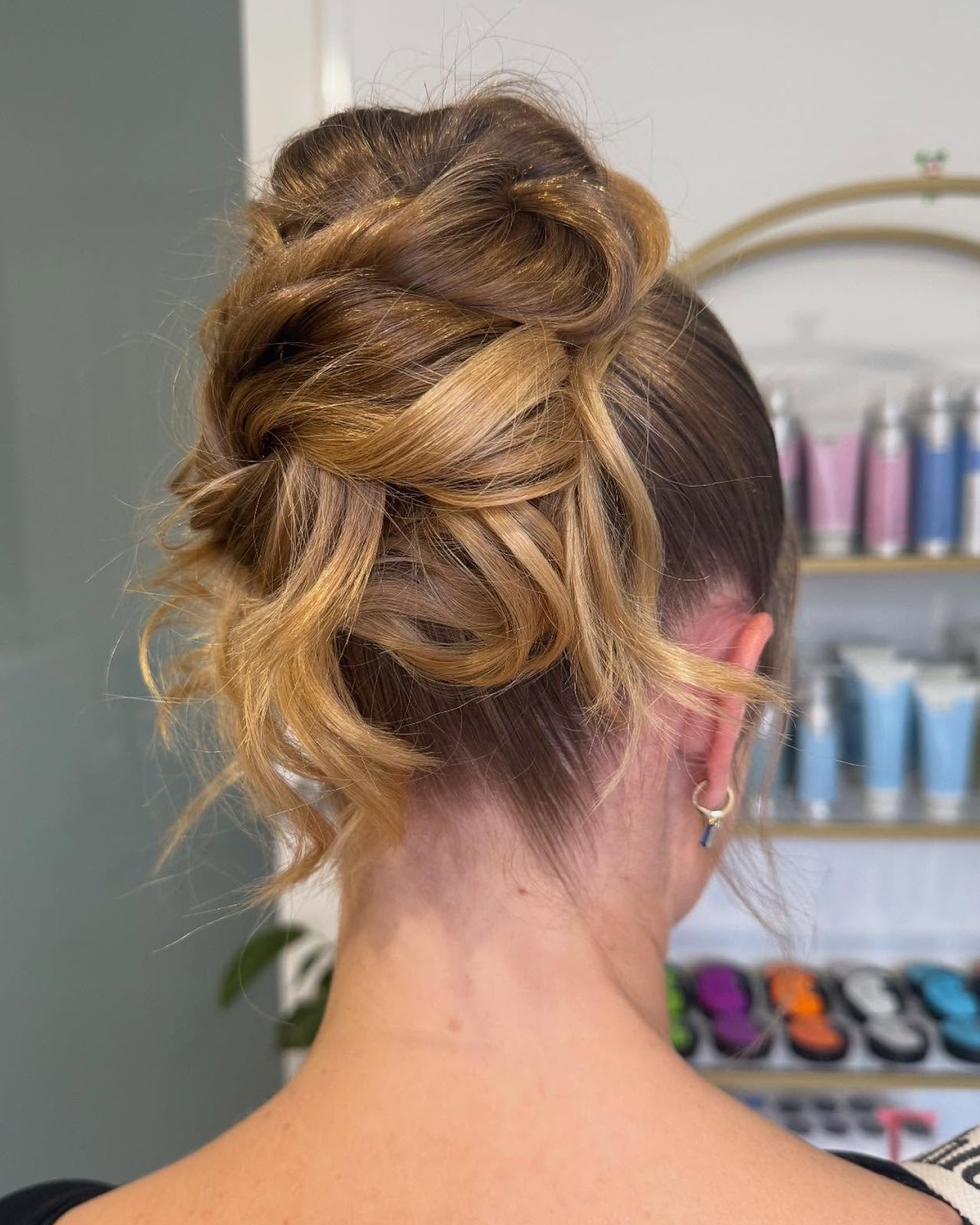 Updo Twisted Bun With Loose Tendrils Visual Idea — Graduation Hairstyles 2027 for Medium Hair