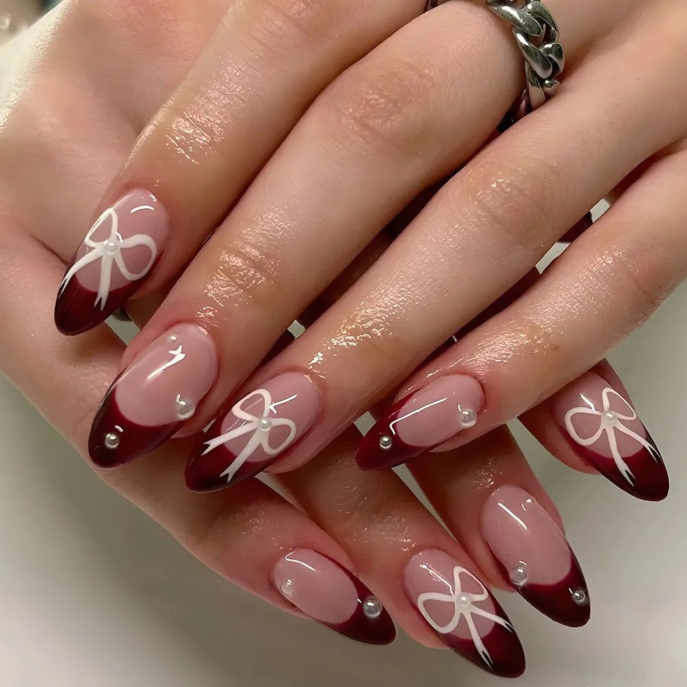Medium Almond Burgundy French With White Bows And Pearls Medium Almond Burgundy French With White Bows And Pearls — Bow French Tip Nails 2027