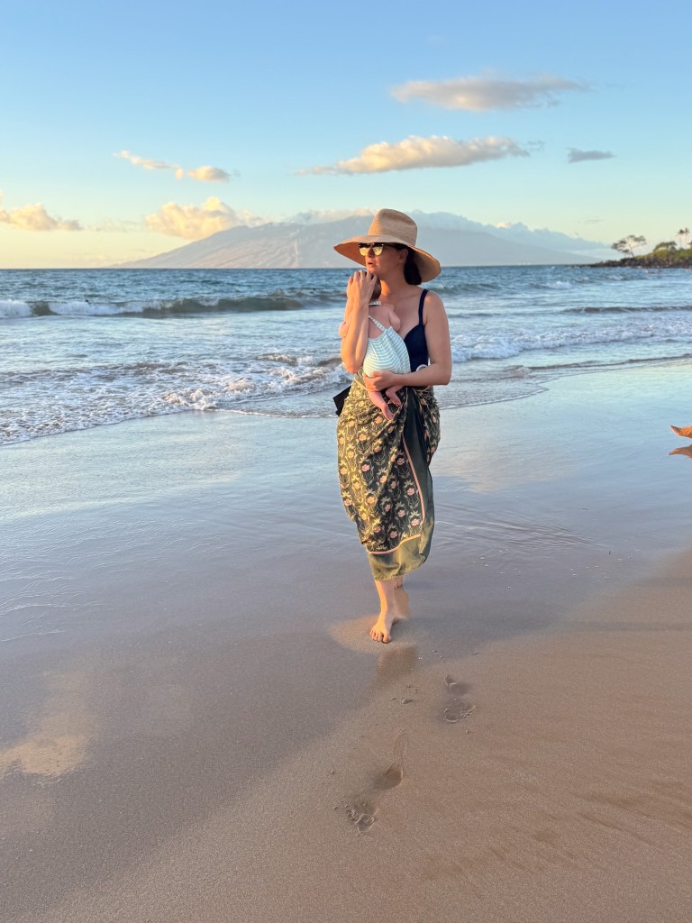 Patterned Sarong Over Black Swimsuit — Spring Break Beach Outfits 2027