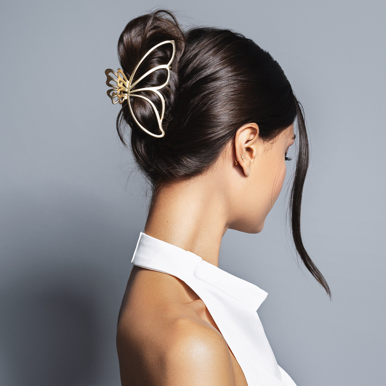 Sleek Dark Brown Bun With Golden Butterfly Clip Sleek Dark Brown Bun With Golden Butterfly Clip — Butterfly Hair Clip Hairstyles 2027