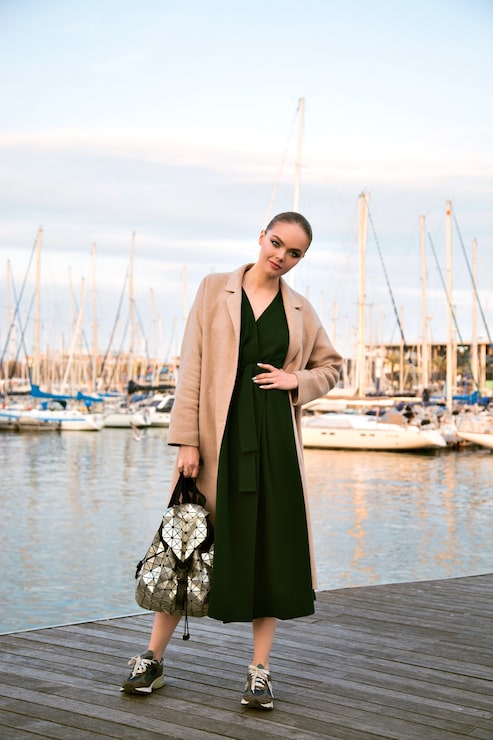 Dark Green Midi Dress with Beige Coat and Sneakers Dark Green Midi Dress with Beige Coat and Sneakers — Yacht Outfits 2027