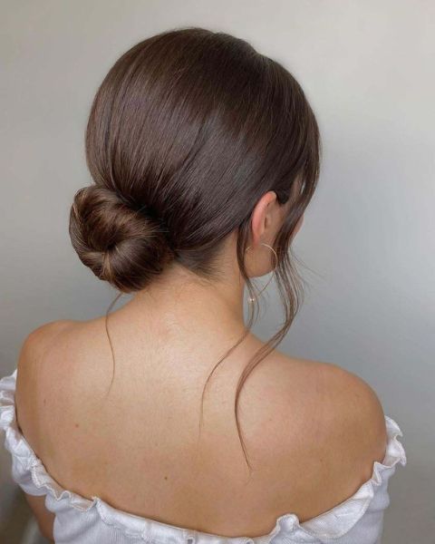 Low Bun With Soft Side-Swept Bangs Low Bun With Soft Side-Swept Bangs — Sleek Bun 2027