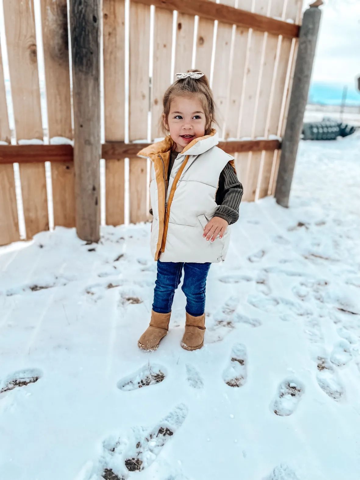 Puffer Vest Layered Over Knit Sweater and Jeans Puffer Vest Layered Over Knit Sweater and Jeans — Toddler Girl Outfits 2027