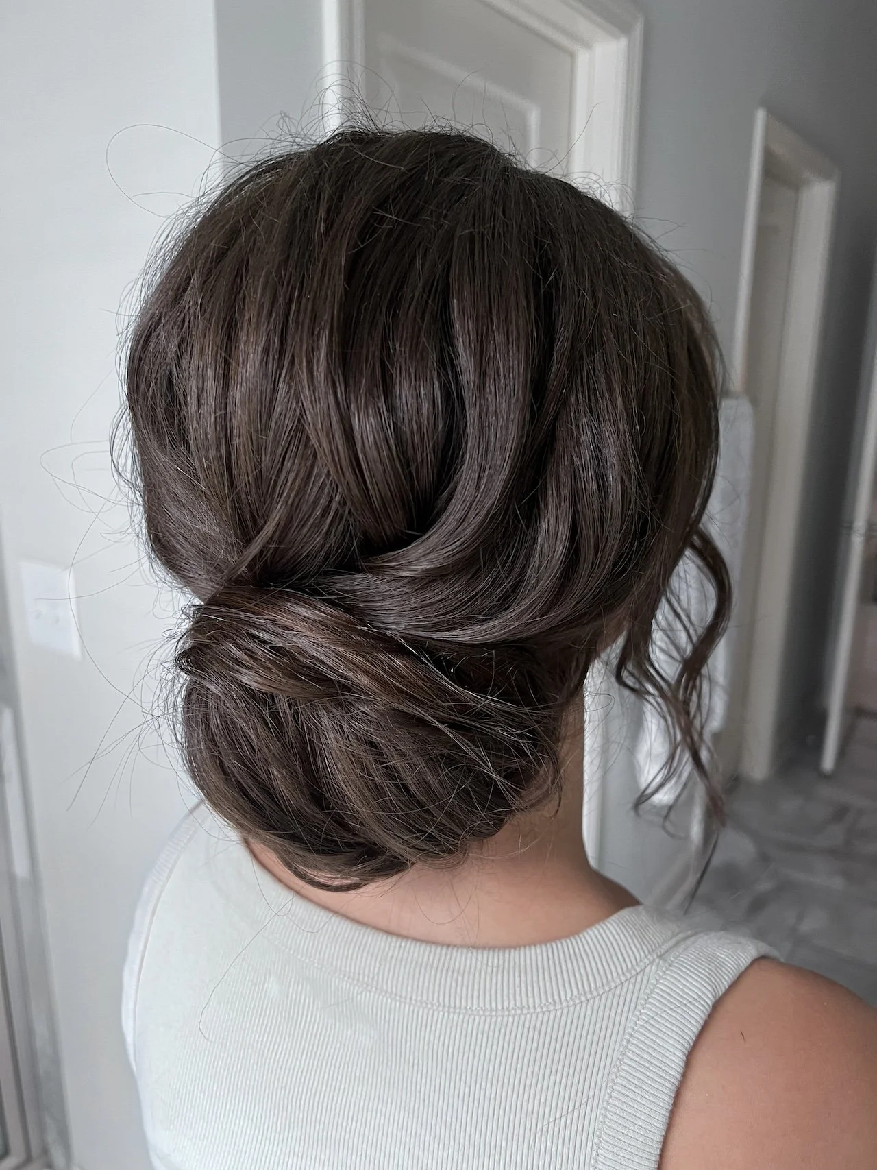Soft Twisted Low Bun With Tendrils — Wedding Updos 2027