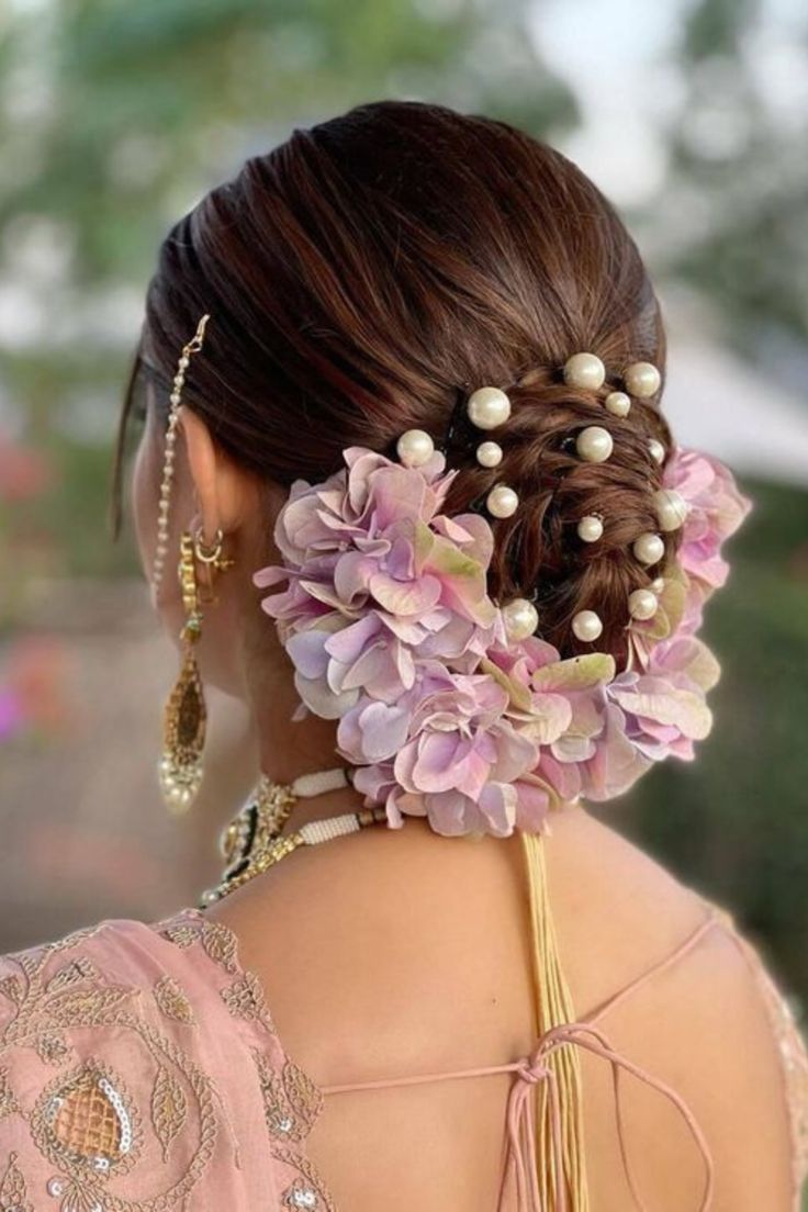 Dark Brown Low Bun with Floral Accents Dark Brown Low Bun with Floral Accents — Side Bun Hairstyles 2027