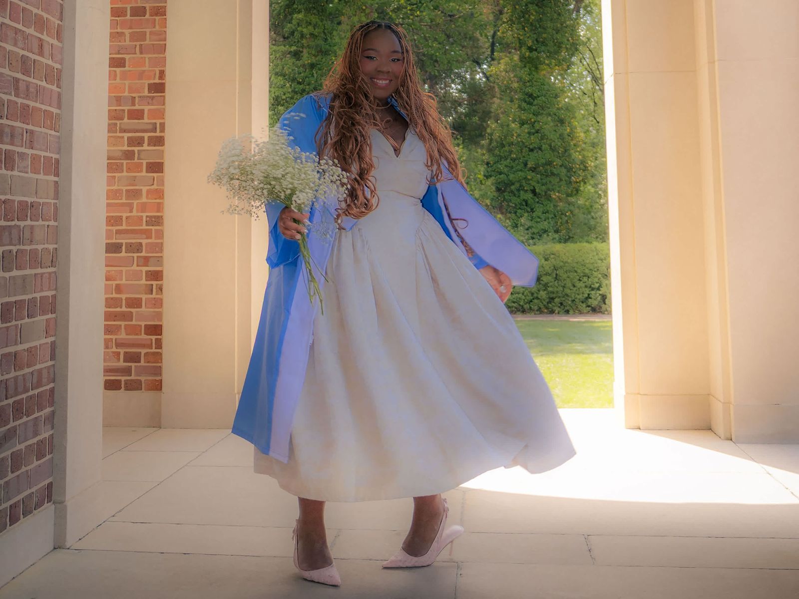 Blue Graduation Gown Over White Dress with Pink Heels — Graduation Speaker Outfits 2027