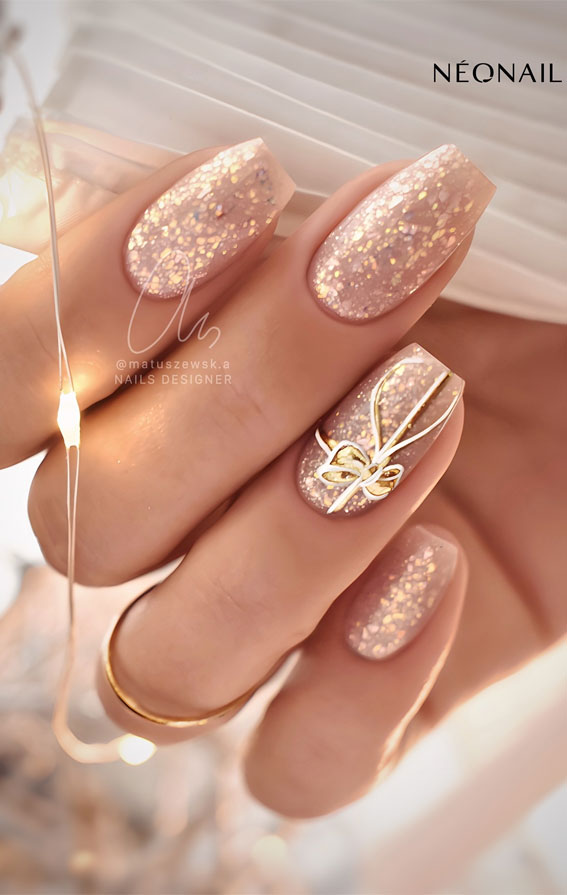 Champagne Glitter 3D Gold Bow Coffin Nails Champagne Glitter 3D Gold Bow Coffin Nails — Neutral Christmas Nails 2026