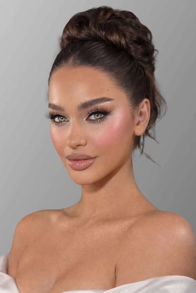 High Sleek Blonde Bun With Middle Part — The Framing Is A Front View High Sleek Blonde Bun With Middle Part — The Framing Is A Front View — Sleek Bun 2027