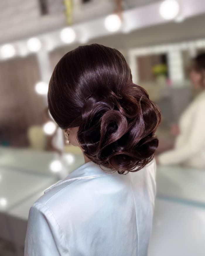 Intricate Dark Brown Rolled Updo — Graduation Updos 2027