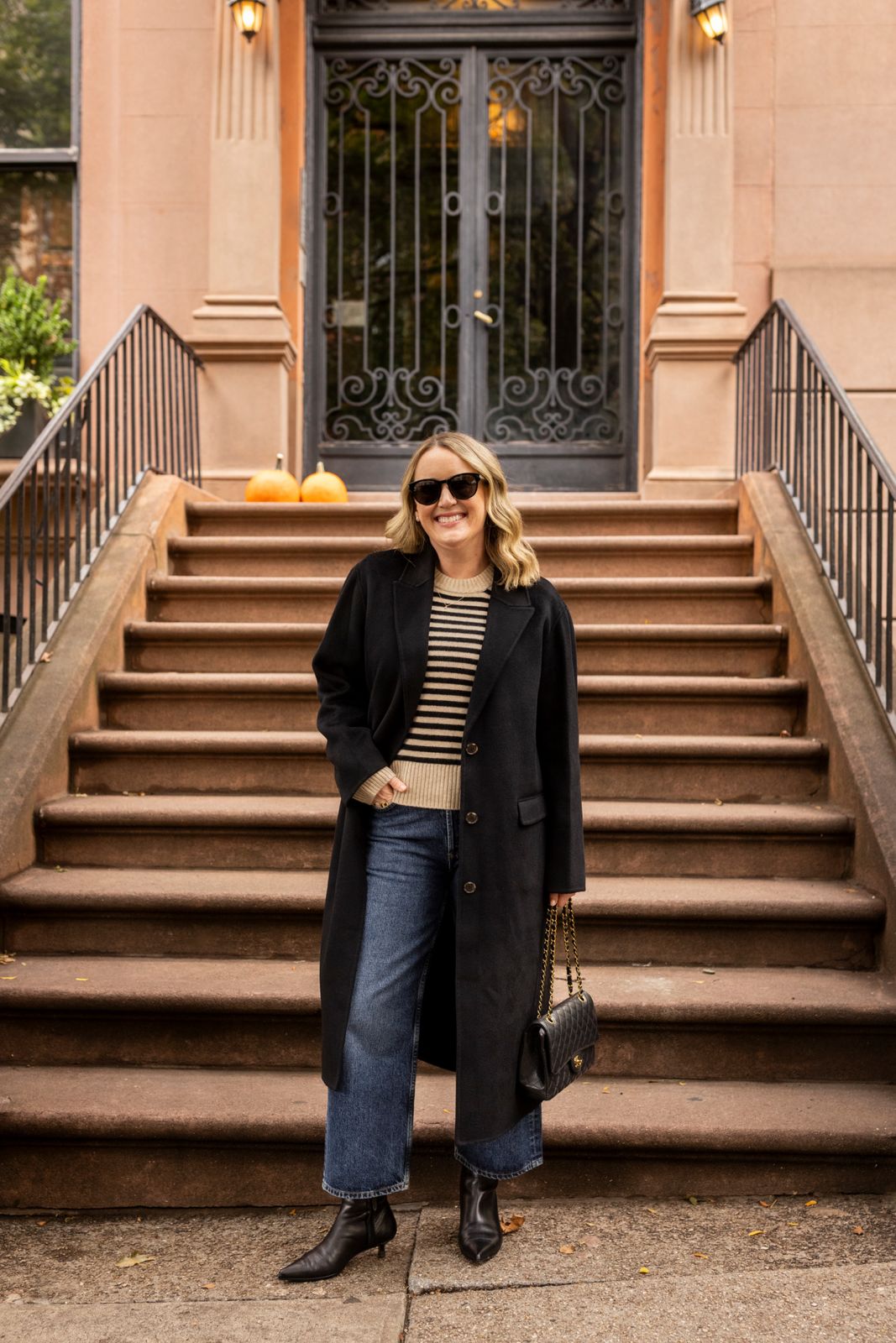 Long Black Coat Over Stripes and Wide-Leg Jeans Long Black Coat Over Stripes and Wide-Leg Jeans — Winter Outfits Warm Climate 2027