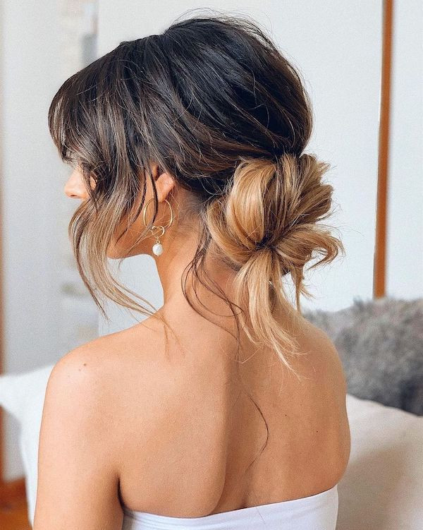 Messy Low Bun With Caramel Highlights Messy Low Bun With Caramel Highlights — Christmas Photo Hairstyles 2026