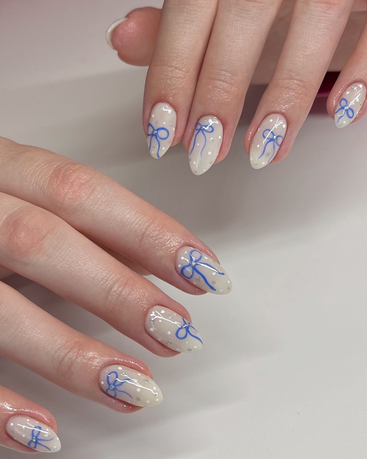 Off-White Oval with Blue Bows and Silver Dots Off-White Oval with Blue Bows and Silver Dots — Long Bow Nails 2027
