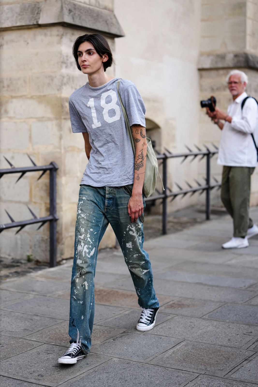 Grey T-Shirt With White Number 15 Print Outfit Idea — Bootcut Jeans Outfits 2027 with Converse