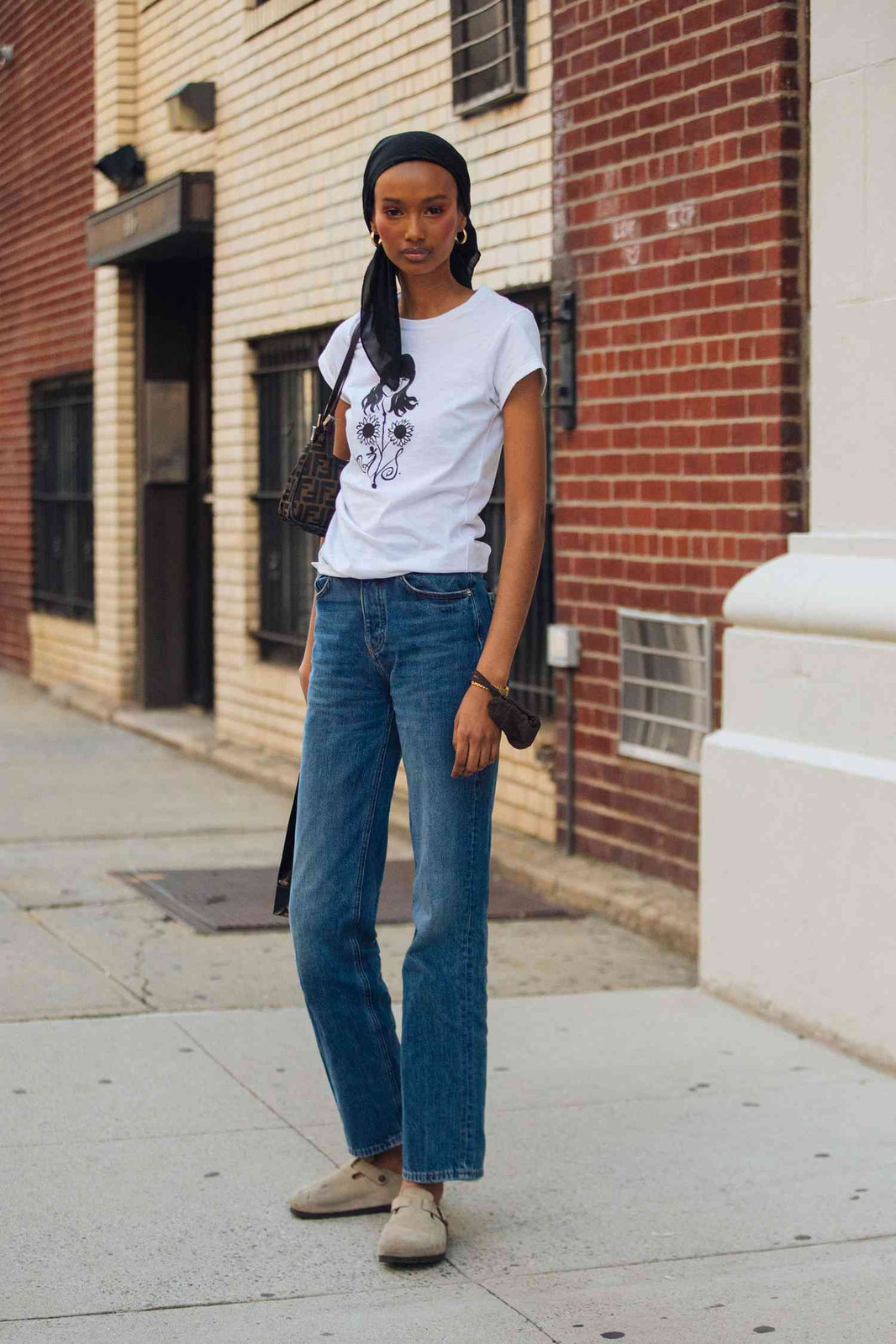 Graphic T-Shirt with Black Headscarf and Beige Suede Birkenstocks Graphic T-Shirt with Black Headscarf and Beige Suede Birkenstocks — Bootcut Jeans Outfits 2027 with Birkenstocks